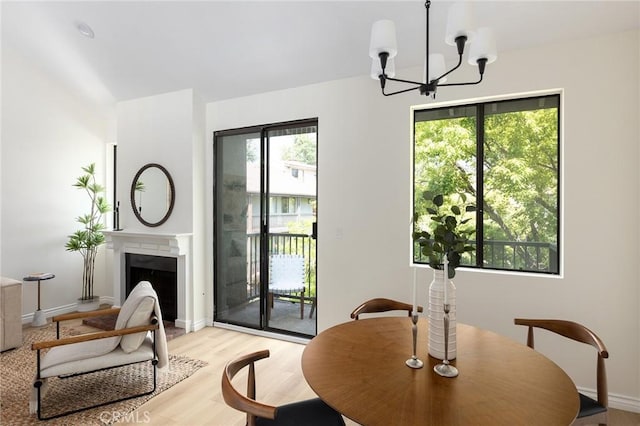 330 Cordova St Unit 322, Pasadena, CA 91101 - dining area featuring a chandelier, plenty of natural light, light wood-style floors, and baseboards