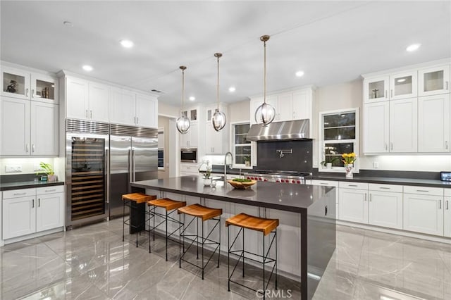 56 Claudius Ct, Irvine, CA 92618 - kitchen featuring under cabinet range hood, dark countertops, light marble finish floors, built in refrigerator, and recessed lighting