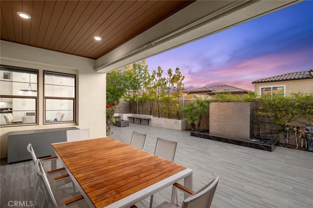 56 Claudius Ct, Irvine, CA 92618 - patio terrace at dusk featuring outdoor dining area and a wooden deck