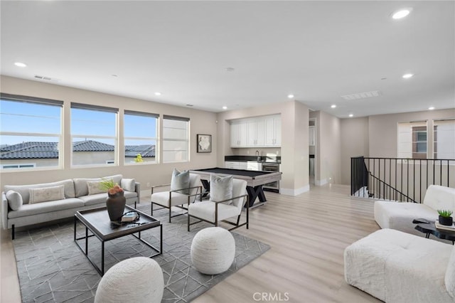 56 Claudius Ct, Irvine, CA 92618 - living area featuring recessed lighting, light wood-style floors, and baseboards