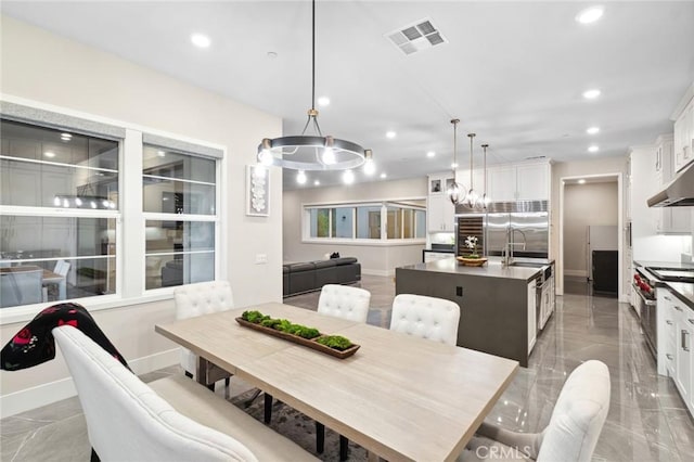 56 Claudius Ct, Irvine, CA 92618 - dining space featuring recessed lighting, light marble finish floors, baseboards, and a chandelier