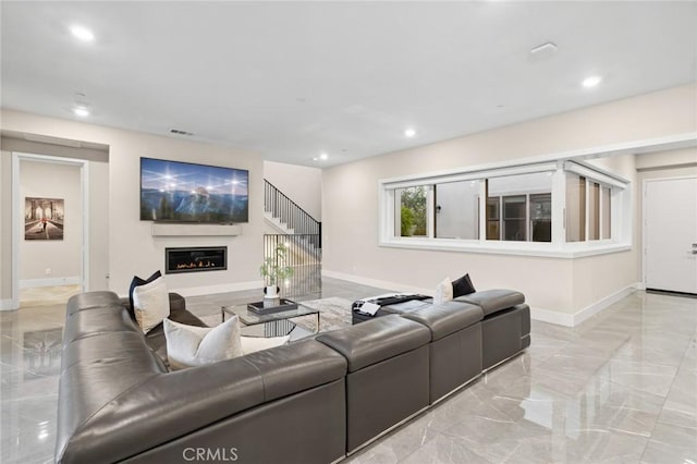 56 Claudius Ct, Irvine, CA 92618 - living room with marble tiled floors, baseboards, a glass covered fireplace, and recessed lighting