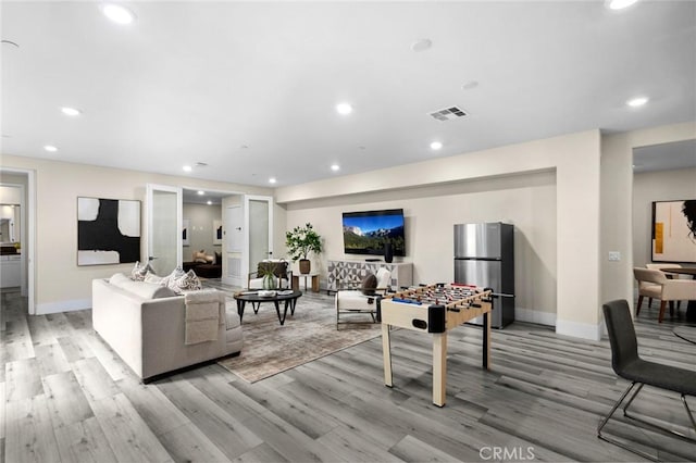 56 Claudius Ct, Irvine, CA 92618 - living room with light wood-style flooring, baseboards, and recessed lighting