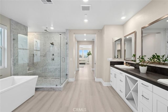 56 Claudius Ct, Irvine, CA 92618 - full bath featuring a stall shower, a soaking tub, wood finished floors, double vanity, and recessed lighting