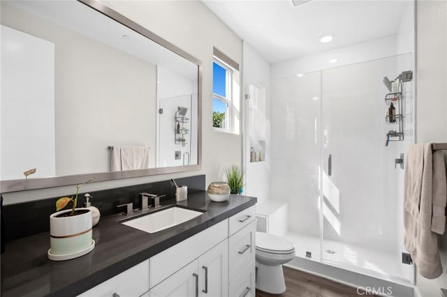 56 Claudius Ct, Irvine, CA 92618 - full bathroom featuring vanity, toilet, a stall shower, wood finished floors, and recessed lighting