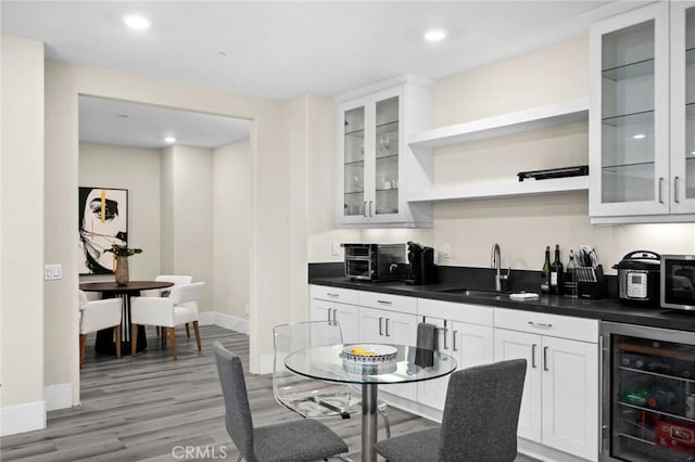 56 Claudius Ct, Irvine, CA 92618 - kitchen featuring wine cooler, a sink, open shelves, dark countertops, and white cabinetry