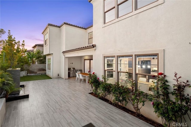 56 Claudius Ct, Irvine, CA 92618 - back of house featuring stucco siding, a tile roof, and a patio