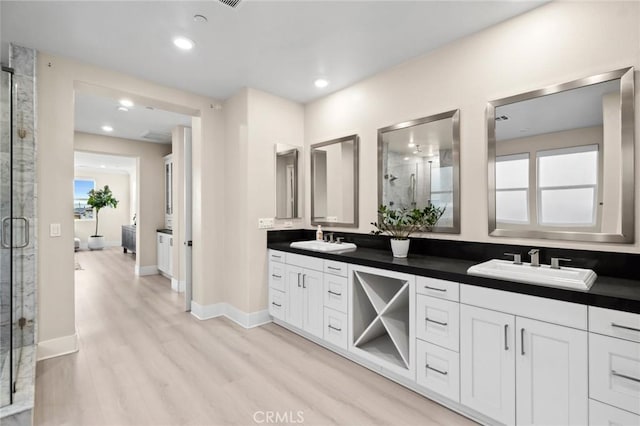 56 Claudius Ct, Irvine, CA 92618 - full bath with a stall shower, double vanity, wood finished floors, baseboards, and recessed lighting