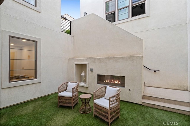 56 Claudius Ct, Irvine, CA 92618 - rear view of house featuring a glass covered fireplace and stucco siding