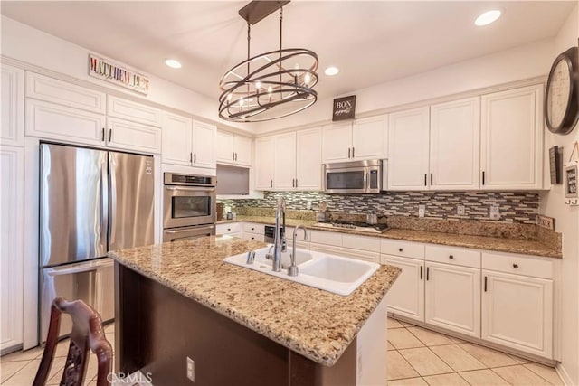668 Corte Sol, Camarillo, CA 93010 - kitchen with appliances with stainless steel finishes, light tile patterned flooring, a sink, a chandelier, and white cabinets