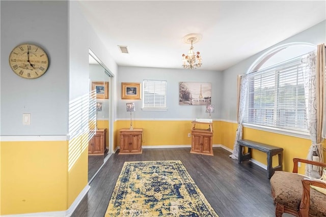 668 Corte Sol, Camarillo, CA 93010 - living area with healthy amount of natural light, dark wood finished floors, a chandelier, and baseboards