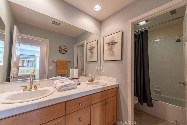 668 Corte Sol, Camarillo, CA 93010 - bathroom featuring double vanity, shower / bath combo with shower curtain, toilet, and tile patterned flooring