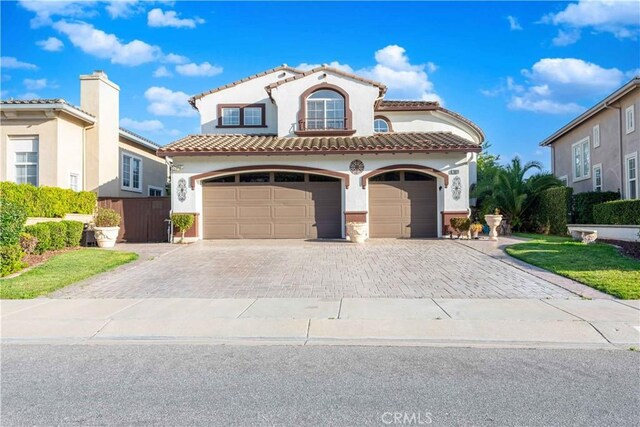 668 Corte Sol, Camarillo, CA 93010 - mediterranean / spanish-style house featuring decorative driveway, stucco siding, a tile roof, and an attached garage