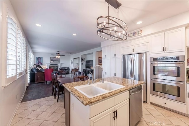 668 Corte Sol, Camarillo, CA 93010 - kitchen with appliances with stainless steel finishes, a sink, a fireplace, a chandelier, and light tile patterned floors