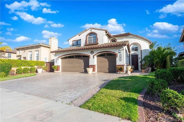 668 Corte Sol, Camarillo, CA 93010 - mediterranean / spanish home featuring a garage, stucco siding, decorative driveway, a tile roof, and a front yard