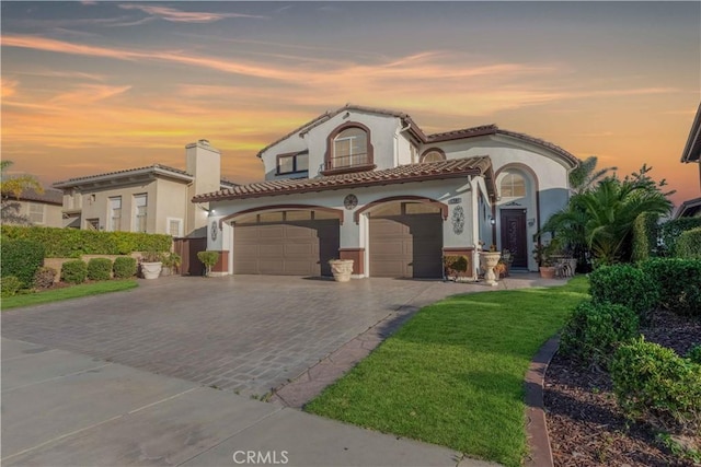 668 Corte Sol, Camarillo, CA 93010 - mediterranean / spanish house with an attached garage, stucco siding, decorative driveway, a tiled roof, and a chimney