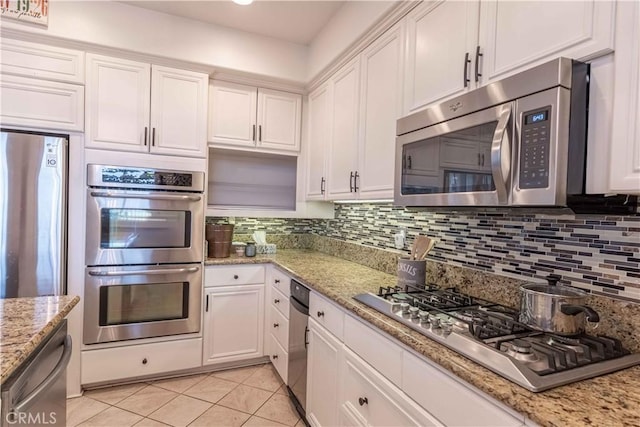 668 Corte Sol, Camarillo, CA 93010 - kitchen featuring appliances with stainless steel finishes, white cabinets, light tile patterned flooring, and decorative backsplash