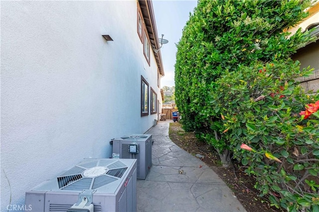 668 Corte Sol, Camarillo, CA 93010 - view of side of home featuring stucco siding, central AC, and a patio