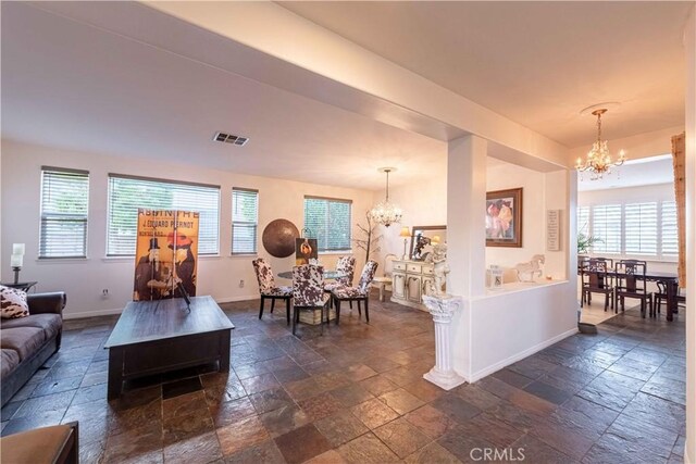668 Corte Sol, Camarillo, CA 93010 - living area with a chandelier, stone tile flooring, and baseboards
