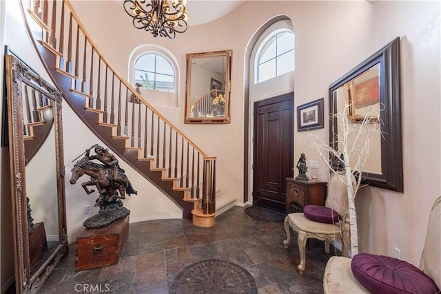 668 Corte Sol, Camarillo, CA 93010 - entryway with plenty of natural light, stairs, a towering ceiling, stone finish floors, and a chandelier