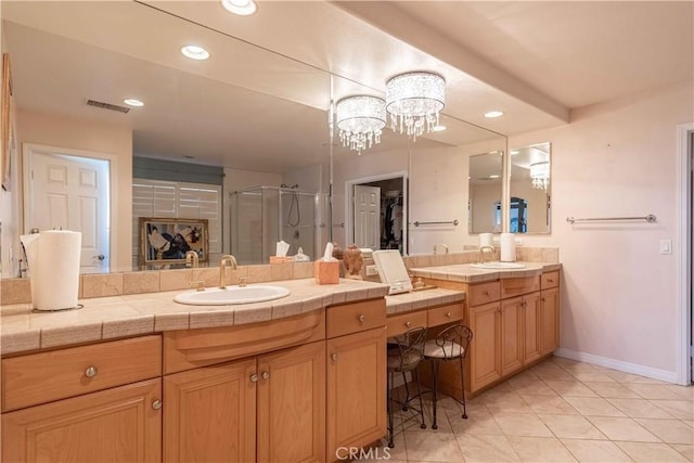 668 Corte Sol, Camarillo, CA 93010 - full bathroom featuring a stall shower, vanity, a chandelier, tile patterned flooring, and baseboards