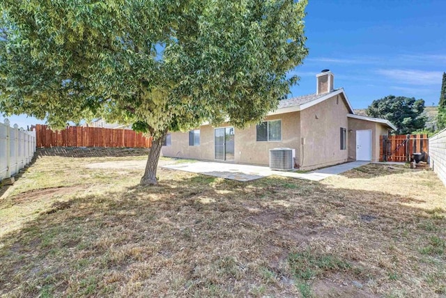 1036 W Gilman St, Banning, CA 92220 - back of house featuring a fenced backyard, a patio, stucco siding, and a chimney