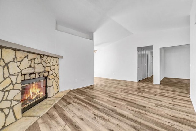 1036 W Gilman St, Banning, CA 92220 - unfurnished living room with wood finished floors and a fireplace