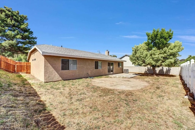 1036 W Gilman St, Banning, CA 92220 - back of property featuring a fenced backyard, a patio, and stucco siding