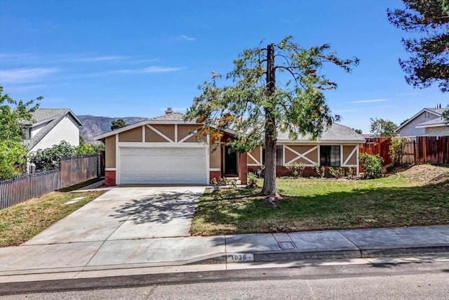 1036 W Gilman St, Banning, CA 92220 - tudor home with an attached garage, driveway, stucco siding, and brick siding