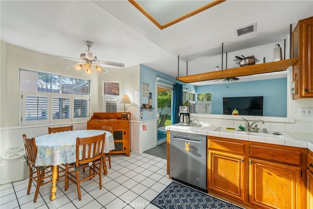 10880 Colusa St, Rancho Cucamonga, CA 91701 - kitchen featuring stainless steel dishwasher, open floor plan, a sink, ceiling fan, and a wainscoted wall
