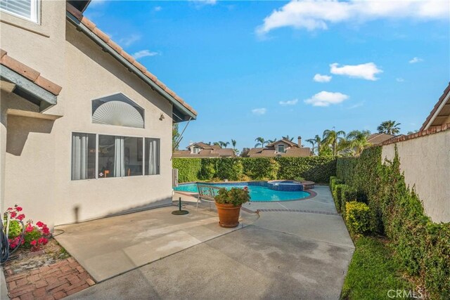 10880 Colusa St, Rancho Cucamonga, CA 91701 - view of swimming pool featuring a patio, a fenced backyard, and a pool with connected hot tub