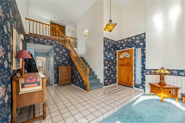10880 Colusa St, Rancho Cucamonga, CA 91701 - entrance foyer featuring wallpapered walls, a towering ceiling, stairs, and tile patterned floors