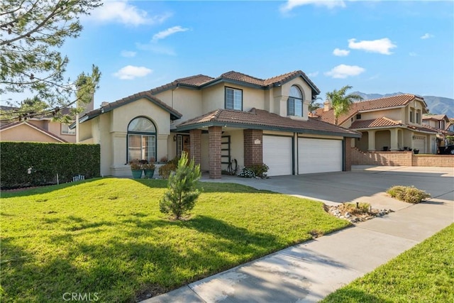 10880 Colusa St, Rancho Cucamonga, CA 91701 - mediterranean / spanish-style home with driveway, stucco siding, a front lawn, a garage, and brick siding