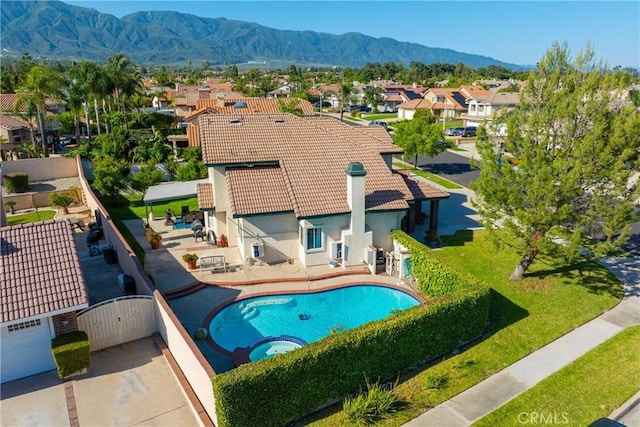 10880 Colusa St, Rancho Cucamonga, CA 91701 - rear view of house featuring a tile roof, a residential view, a pool with connected hot tub, stucco siding, and a mountain view