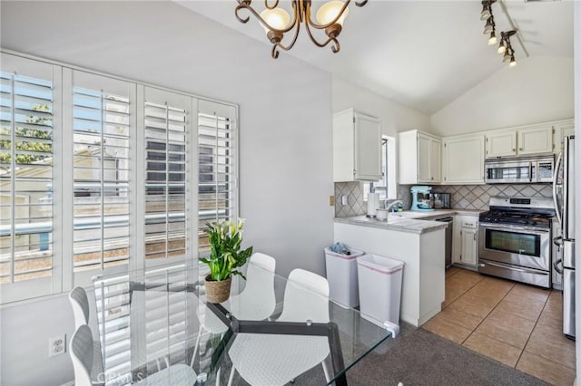 18107 Erik Ct Unit 462, Canyon Country, CA 91387 - kitchen featuring appliances with stainless steel finishes, a chandelier, tasteful backsplash, a sink, and vaulted ceiling