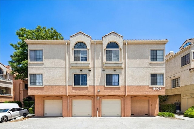 18107 Erik Ct Unit 462, Canyon Country, CA 91387 - view of front of property with stucco siding, a garage, driveway, and a tile roof