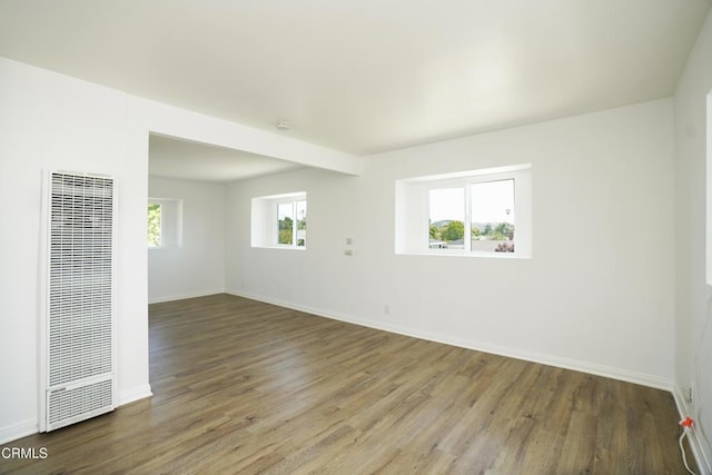 513 E Comstock Ave, Glendora, CA 91741 - empty room with a heating unit and wood finished floors