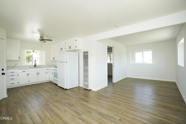 513 E Comstock Ave, Glendora, CA 91741 - kitchen featuring white appliances, a heating unit, light countertops, ceiling fan, and plenty of natural light