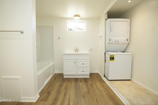 513 E Comstock Ave, Glendora, CA 91741 - laundry area featuring stacked washer / drying machine and wood finished floors