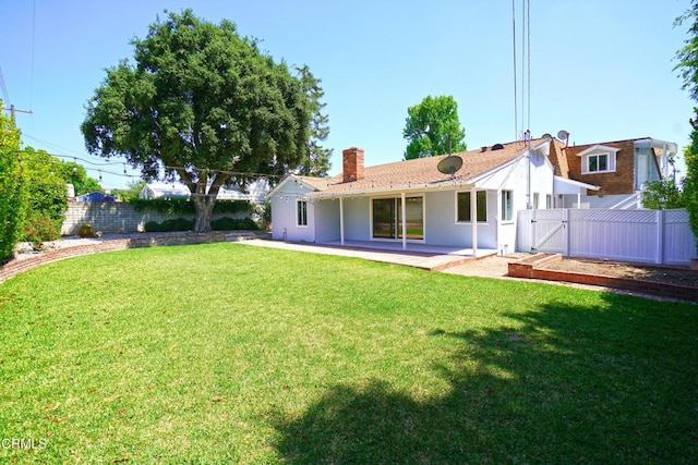 513 E Comstock Ave, Glendora, CA 91741 - back of property with a gate, a patio area, a fenced backyard, a chimney, and stucco siding