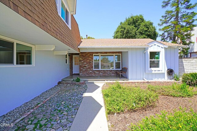 513 E Comstock Ave, Glendora, CA 91741 - view of front facade featuring board and batten siding, roof with shingles, and brick siding
