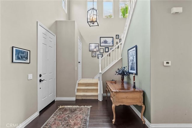 28409 Connick Pl, Saugus, CA 91350 - foyer entrance with dark wood-style flooring, baseboards, a towering ceiling, stairs, and plenty of natural light