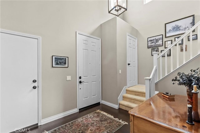 28409 Connick Pl, Saugus, CA 91350 - foyer entrance with dark wood-style flooring, stairs, baseboards, and a towering ceiling