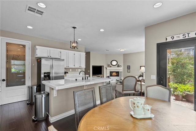 28409 Connick Pl, Saugus, CA 91350 - dining room featuring dark wood-style floors, recessed lighting, a lit fireplace, and baseboards