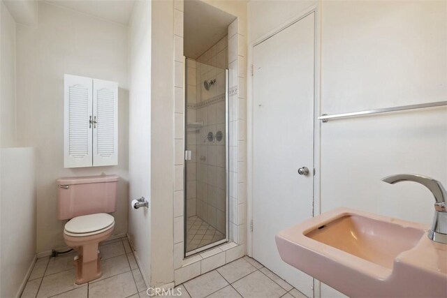 13126 Roscoe Blvd, Sun Valley, CA 91352 - full bathroom with a sink, toilet, a shower stall, and tile patterned floors
