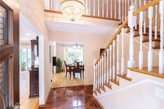 11811 Louise Ave, Granada Hills, CA 91344 - entrance foyer with a chandelier, baseboards, stairway, a towering ceiling, and parquet floors