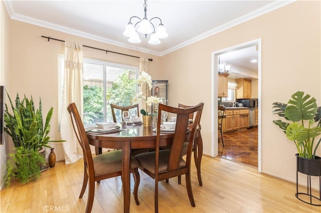 11811 Louise Ave, Granada Hills, CA 91344 - dining room with a chandelier, light wood finished floors, and ornamental molding