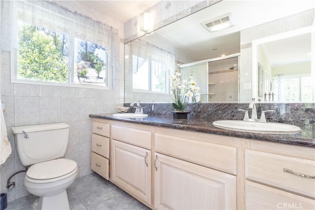 11811 Louise Ave, Granada Hills, CA 91344 - bathroom with tile walls, double vanity, plenty of natural light, toilet, and a stall shower