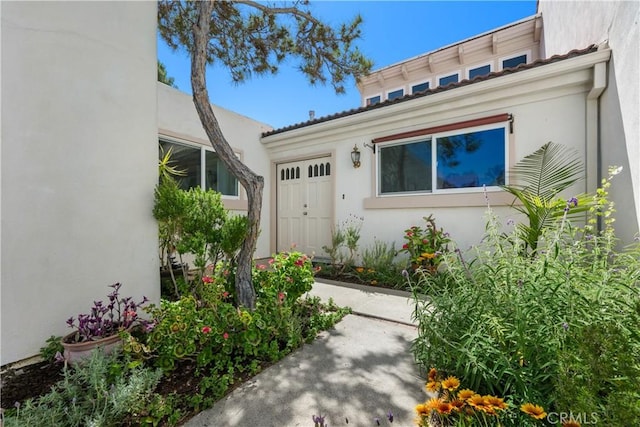 20 Mandrake Way, Irvine, CA 92612 - view of exterior entry featuring stucco siding and an attached garage