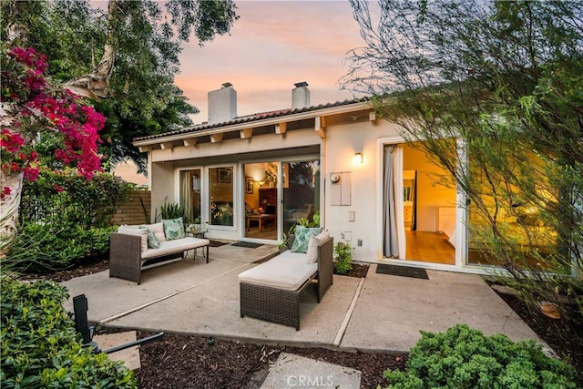 20 Mandrake Way, Irvine, CA 92612 - back of property featuring a chimney, stucco siding, a patio, and an outdoor living space